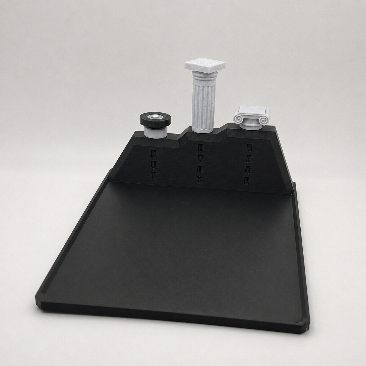 Assembly fixture loaded with the nut, body, and head components